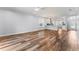 Open living space featuring hardwood floors, recessed lighting, and a modern kitchen in the background at 137 Silver Falls Dr, Apollo Beach, FL 33572