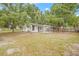 View of the backyard and the back side of the house with large trees at 1401 30Th N Ave, St Petersburg, FL 33704