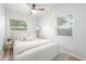 Bright bedroom with a ceiling fan, two windows, and neutral decor at 1401 30Th N Ave, St Petersburg, FL 33704