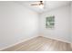 Bright bedroom with light wood flooring, a window, and a ceiling fan at 1401 30Th N Ave, St Petersburg, FL 33704