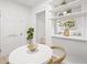 Dining area showcases open shelving and complements the modern white decor throughout the home at 1401 30Th N Ave, St Petersburg, FL 33704