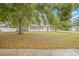 View of a cozy house with a well-manicured lawn and mature trees, showcasing its peaceful setting at 1401 30Th N Ave, St Petersburg, FL 33704