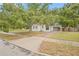 The exterior of a well-kept home with mature trees, green grass, and a paved sidewalk at 1401 30Th N Ave, St Petersburg, FL 33704