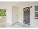 Exterior door featuring covered entry, secure lock, and wall-mounted light fixture at 1401 30Th N Ave, St Petersburg, FL 33704
