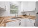 Corner view of the bright kitchen featuring butcher block countertops and stainless steel sink at 1401 30Th N Ave, St Petersburg, FL 33704