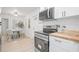 Bright kitchen featuring stainless steel appliances, dining area, and crisp white walls at 1401 30Th N Ave, St Petersburg, FL 33704