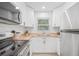 Bright kitchen featuring white cabinets, butcher block countertops, stainless appliances, and subway tile backsplash at 1401 30Th N Ave, St Petersburg, FL 33704
