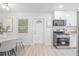 Modern kitchen seamlessly connected to the dining area, features stainless steel appliances and ample lighting at 1401 30Th N Ave, St Petersburg, FL 33704