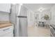 Bright kitchen leading into dining area with stainless steel refrigerator and stainless steel appliances at 1401 30Th N Ave, St Petersburg, FL 33704