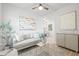 Bright living room features a plush gray sofa and stylish decor with an open view into dining area at 1401 30Th N Ave, St Petersburg, FL 33704