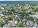 High angle aerial view of a suburban neighborhood showcasing green trees and various residential homes at 1421 Dew Bloom Rd, Valrico, FL 33594
