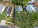 Aerial view of a home surrounded by a wooden fence and lush trees in a residential neighborhood at 1421 Dew Bloom Rd, Valrico, FL 33594