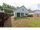 Backyard view featuring a grass yard, a potted tree, and a wooden fence at 1421 Dew Bloom Rd, Valrico, FL 33594