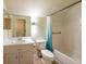 Bathroom featuring a vanity sink, toilet, and shower with a blue curtain at 1421 Dew Bloom Rd, Valrico, FL 33594