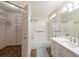Bathroom with shower-tub combo, white cabinets, and access to walk-in closet at 1421 Dew Bloom Rd, Valrico, FL 33594
