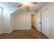 Carpeted bedroom featuring a ceiling fan, a closet, and access to a hallway at 1421 Dew Bloom Rd, Valrico, FL 33594