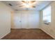A cozy bedroom with a ceiling fan, carpet and closet, and window at 1421 Dew Bloom Rd, Valrico, FL 33594