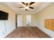 Bedroom with wood floors, neutral walls, closet and ensuite bathroom at 1421 Dew Bloom Rd, Valrico, FL 33594