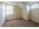 A bright bedroom featuring carpet, neutral walls, and natural light from large window at 1421 Dew Bloom Rd, Valrico, FL 33594