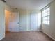A cozy bedroom featuring carpet and window, with white trim and neutral walls at 1421 Dew Bloom Rd, Valrico, FL 33594