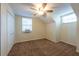 Bedroom featuring neutral walls, carpeted floor, ceiling fan and large window at 1421 Dew Bloom Rd, Valrico, FL 33594