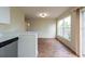 Bright dining room area with large windows, sliding glass door, and hardwood floors at 1421 Dew Bloom Rd, Valrico, FL 33594