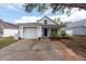 Charming single-Gathering home featuring a garage and well-maintained yard at 1421 Dew Bloom Rd, Valrico, FL 33594