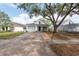 Charming single-Gathering home featuring a well-manicured front yard with a driveway leading to a one-car garage at 1421 Dew Bloom Rd, Valrico, FL 33594