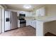 Kitchen boasts stainless appliances, bright white cabinetry, and a breakfast bar at 1421 Dew Bloom Rd, Valrico, FL 33594