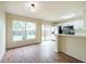 Eat-in kitchen featuring wood-look floors, and sliding glass door to the backyard at 1421 Dew Bloom Rd, Valrico, FL 33594
