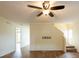 Inviting living room featuring neutral paint, modern ceiling fan, and beautiful laminate flooring at 1421 Dew Bloom Rd, Valrico, FL 33594