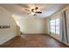 Spacious living room featuring wood floors, neutral walls, and a ceiling fan at 1421 Dew Bloom Rd, Valrico, FL 33594