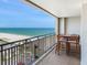 Enjoy beautiful ocean views from this condo balcony with a table and chairs at 1430 Gulf Blvd # 707, Clearwater Beach, FL 33767