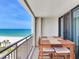 This condo balcony features a dining table with ocean views at 1430 Gulf Blvd # 707, Clearwater Beach, FL 33767