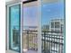 This balcony view features sliding glass doors and a picturesque view of the bay at 1430 Gulf Blvd # 707, Clearwater Beach, FL 33767