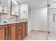 The beautifully designed bathroom offers dual glass vessel sinks, wood cabinets and glass shower at 1430 Gulf Blvd # 707, Clearwater Beach, FL 33767