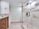 Bathroom boasts a glass vessel sink, wood cabinets, and a frameless glass shower at 1430 Gulf Blvd # 707, Clearwater Beach, FL 33767