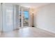 This is a bedroom with white curtains leading to a balcony with a ocean view at 1430 Gulf Blvd # 707, Clearwater Beach, FL 33767