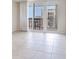 This is a bedroom with white curtains leading to a balcony with a city view at 1430 Gulf Blvd # 707, Clearwater Beach, FL 33767