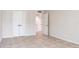 This bright bedroom features neutral walls, tile floors, and doors to the hallway and closet at 1430 Gulf Blvd # 707, Clearwater Beach, FL 33767