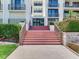 Inviting entrance with beautiful brick stairs and lush landscaping around the condo building at 1430 Gulf Blvd # 707, Clearwater Beach, FL 33767