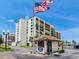 Beautiful beachfront condo complex with the American flag in the foreground at 1430 Gulf Blvd # 707, Clearwater Beach, FL 33767