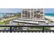 A view from the balcony shows the building, parking and beautiful beach at 1430 Gulf Blvd # 707, Clearwater Beach, FL 33767