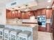 This kitchen features a large island with seating, stainless steel appliances, and custom cabinetry at 1430 Gulf Blvd # 707, Clearwater Beach, FL 33767