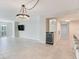 Open living room featuring modern lighting, a bar area with a wine fridge, and sleek tile floors at 1430 Gulf Blvd # 707, Clearwater Beach, FL 33767