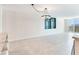 Spacious living room features an elegant chandelier, tile flooring, and ample natural light at 1430 Gulf Blvd # 707, Clearwater Beach, FL 33767