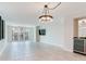 Large living area featuring tile floors, balcony access, and bar area offering serene views at 1430 Gulf Blvd # 707, Clearwater Beach, FL 33767