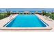 A refreshing community pool with plenty of lounge chairs and umbrellas at 1430 Gulf Blvd # 707, Clearwater Beach, FL 33767