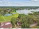 Scenic aerial shot showcasing lake and community tennis courts surrounded by lush greenery at 14732 Morning Dr, Lutz, FL 33559