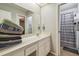 Bright bathroom featuring ample counter space and a shower with striped shower curtain at 14732 Morning Dr, Lutz, FL 33559
